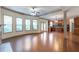 Open living space with hardwood floors, lots of light and kitchen in the background at 1645 Colleens Cask Ter, Dacula, GA 30019