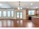 Open concept to dining featuring hardwood floors, windows, sliding glass doors and kitchen access at 1645 Colleens Cask Ter, Dacula, GA 30019