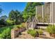 Inviting backyard with stone patio, terraced landscaping, wooden deck, and lush lawn at 3641 Carriage Glen Way, Dacula, GA 30019