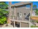 A multi-story house displays its backyard with a deck, stone patio, and well-maintained lawn at 3641 Carriage Glen Way, Dacula, GA 30019