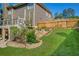 Picturesque backyard with lush lawn, terraced landscaping, wooden fence and elevated deck at 3641 Carriage Glen Way, Dacula, GA 30019