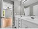 Bright bathroom features a double sink vanity, white cabinetry and shelving, and neutral paint at 3641 Carriage Glen Way, Dacula, GA 30019