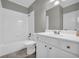 Bathroom showing white tile, white vanity and updated fixtures at 3641 Carriage Glen Way, Dacula, GA 30019