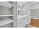 This bathroom features double sinks, white cabinets, and a shelving unit at 3641 Carriage Glen Way, Dacula, GA 30019