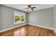 This bedroom features hardwood floors, a ceiling fan, and a window with blinds at 3641 Carriage Glen Way, Dacula, GA 30019