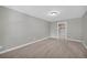 Spacious bedroom featuring neutral carpeting, gray walls, white trim, and a walk-in closet at 3641 Carriage Glen Way, Dacula, GA 30019