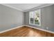 Bright bedroom with hardwood floors and a large window, offering natural light and a cozy atmosphere at 3641 Carriage Glen Way, Dacula, GA 30019