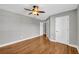 This bedroom features hardwood floors, a ceiling fan, and white doors at 3641 Carriage Glen Way, Dacula, GA 30019