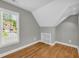 This bedroom features an angular ceiling, built-in shelves, and hardwood floors at 3641 Carriage Glen Way, Dacula, GA 30019