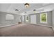 Spacious bonus room with neutral carpet, trey ceiling and recessed lights at 3641 Carriage Glen Way, Dacula, GA 30019