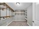 Walk-in closet with metal shelving and neutral carpeting offers ample storage space at 3641 Carriage Glen Way, Dacula, GA 30019