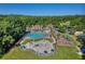 Aerial view of community pool, playground and clubhouse surrounded by mature trees and green space at 3641 Carriage Glen Way, Dacula, GA 30019