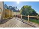 Wooden deck overlooking the backyard with a railing and greenery at 3641 Carriage Glen Way, Dacula, GA 30019