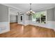 Elegant dining room featuring hardwood floors, decorative molding, and a stylish chandelier fixture at 3641 Carriage Glen Way, Dacula, GA 30019