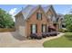 Charming brick two-story home features a manicured lawn, walkway, and two-car garage at 3641 Carriage Glen Way, Dacula, GA 30019