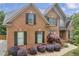 Charming brick two-story home features with shutters and manicured landscaping at 3641 Carriage Glen Way, Dacula, GA 30019