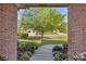 Charming front entrance with brick accents, manicured lawn, and mature landscaping, welcoming guests at 3641 Carriage Glen Way, Dacula, GA 30019