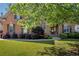 Charming brick home featuring a lush green lawn, mature trees, and manicured landscaping at 3641 Carriage Glen Way, Dacula, GA 30019