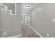Long hallway showcasing gray walls, neutral carpet, an arched doorway, and natural light at 3641 Carriage Glen Way, Dacula, GA 30019