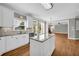 Bright kitchen boasts white cabinets, granite countertops, stainless steel appliances and hardwood floors at 3641 Carriage Glen Way, Dacula, GA 30019