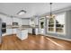 Spacious kitchen features stainless steel appliances, granite countertops, and a center island with white cabinets at 3641 Carriage Glen Way, Dacula, GA 30019
