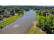 Picturesque view of a tranquil lake surrounded by lush greenery and upscale homes at 3641 Carriage Glen Way, Dacula, GA 30019