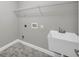 This laundry room features a sink, overhead shelf, and tile floor at 3641 Carriage Glen Way, Dacula, GA 30019