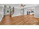 Open living room featuring hardwood floors, staircase, and a view into the kitchen at 3641 Carriage Glen Way, Dacula, GA 30019