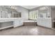 Bright bathroom boasts double sinks, a soaking tub, and tiled floors at 3641 Carriage Glen Way, Dacula, GA 30019