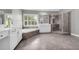 Light-filled bathroom with double vanity, soaking tub, tiled floors, and enclosed shower at 3641 Carriage Glen Way, Dacula, GA 30019