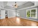 Bright main bedroom featuring hardwood floors, tray ceiling, natural light, and neutral paint at 3641 Carriage Glen Way, Dacula, GA 30019