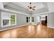 Large main bedroom boasts hardwood floors, tray ceiling, lots of natural light, and a closet at 3641 Carriage Glen Way, Dacula, GA 30019