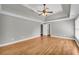 Spacious main bedroom offers hardwood floors, tray ceiling, natural light, and neutral paint at 3641 Carriage Glen Way, Dacula, GA 30019