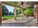 View of the stamped concrete patio with a ceiling fan, pillars, and a scenic backyard at 3641 Carriage Glen Way, Dacula, GA 30019