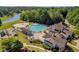 Aerial shot of a large swimming pool and clubhouse with a lake view, perfect for Gathering fun at 3641 Carriage Glen Way, Dacula, GA 30019
