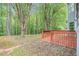 Wood backyard deck surrounded by mature trees, foliage and green grass at 4795 Wilkins Station Dr, Decatur, GA 30035