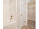 Clean bathroom featuring a white tiled tub and shower combination with a door to the closet at 4795 Wilkins Station Dr, Decatur, GA 30035