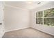 Bedroom with neutral carpet, and bright natural light from large window at 4795 Wilkins Station Dr, Decatur, GA 30035