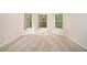 Cozy bedroom with neutral carpet, bright natural light, and three large windows at 4795 Wilkins Station Dr, Decatur, GA 30035