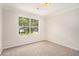 Bedroom with neutral carpet, and bright natural light from large window at 4795 Wilkins Station Dr, Decatur, GA 30035