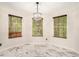 Bright dining area with marble floors, a modern chandelier, and large windows at 4795 Wilkins Station Dr, Decatur, GA 30035