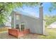 Charming two-story home with wood siding, chimney, and a backyard deck at 4795 Wilkins Station Dr, Decatur, GA 30035