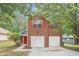 Charming two-story brick home with red shutters and a two-car garage at 4795 Wilkins Station Dr, Decatur, GA 30035