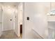 Hallway featuring neutral walls, with bathroom, staircase, and bedroom access at 4795 Wilkins Station Dr, Decatur, GA 30035