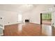 Spacious living room with hardwood floors, fireplace, and access to the outdoor deck at 4795 Wilkins Station Dr, Decatur, GA 30035