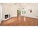 Open concept living room with hardwood floors, fireplace, and sliding glass doors at 4795 Wilkins Station Dr, Decatur, GA 30035