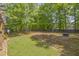 Spacious, fenced backyard with mature trees, offering privacy and room to roam at 1465 Laleiah Dr, Cumming, GA 30041