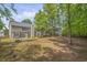 Spacious backyard with a patio, swing, wooden fence, offering ample outdoor living space at 1465 Laleiah Dr, Cumming, GA 30041