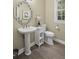 Stylish bathroom featuring a unique mirror, elegant pedestal sink, and modern fixtures at 1465 Laleiah Dr, Cumming, GA 30041
