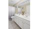 Bright bathroom with double vanity, tile flooring, and a large mirror with Hollywood style lighting at 1465 Laleiah Dr, Cumming, GA 30041